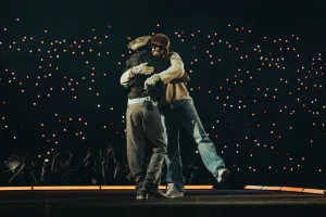 Romeo Santos and Bad Bunny hug on stage during Bad Bunny’s show at the Olympic Stadium on Nov. 22, 2025 in Santo Domingo, Dominican Republic.