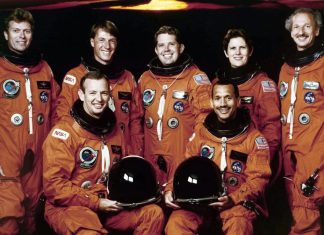 Why do astronauts wear bright orange flight suits?