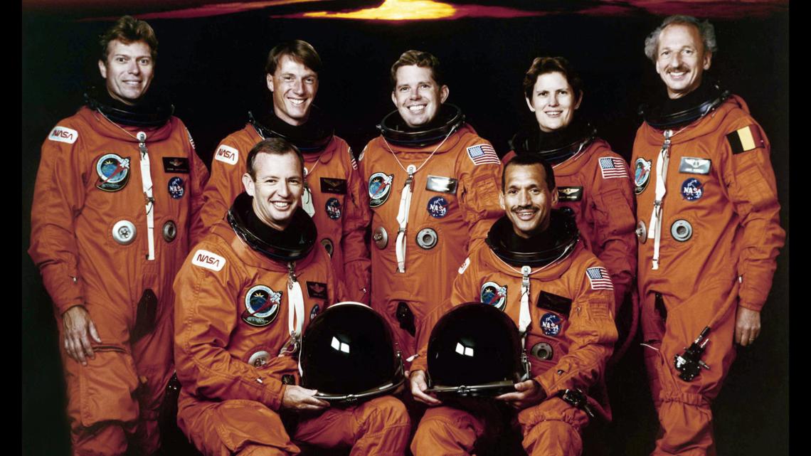Why do astronauts wear bright orange flight suits?